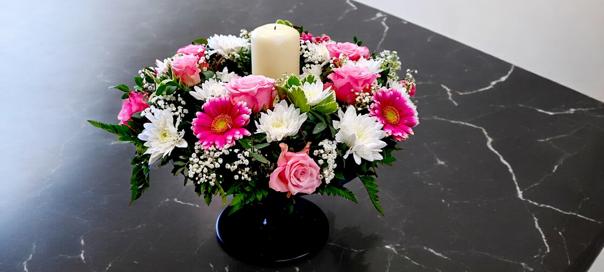 Floral table centerpiece with candle