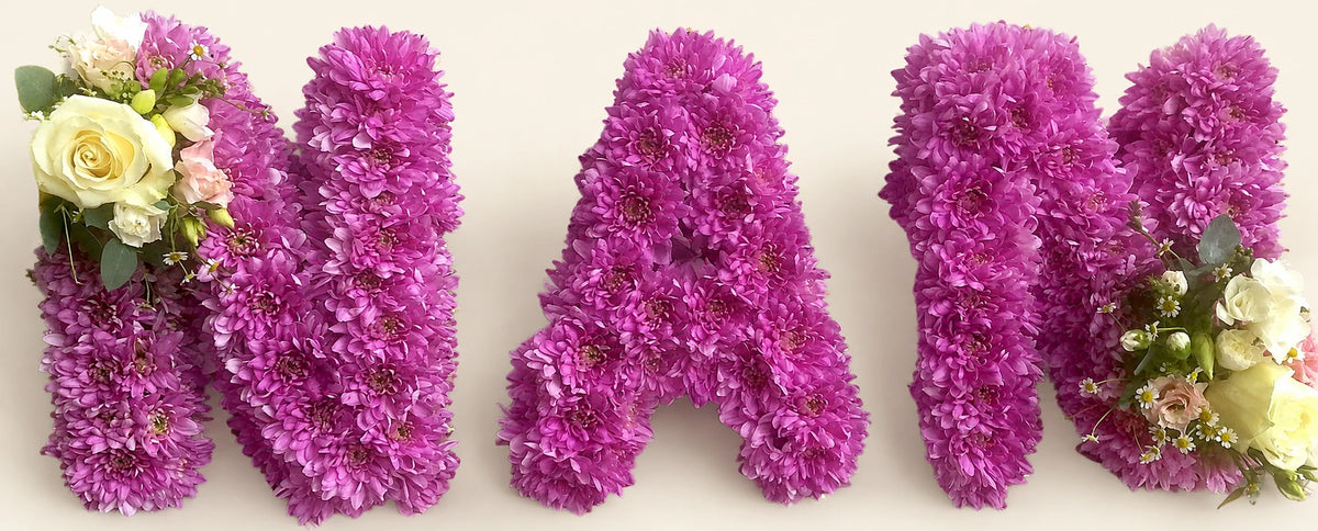 Purple chrysanthemum funeral letters spelling NAN with cream rose corsages
