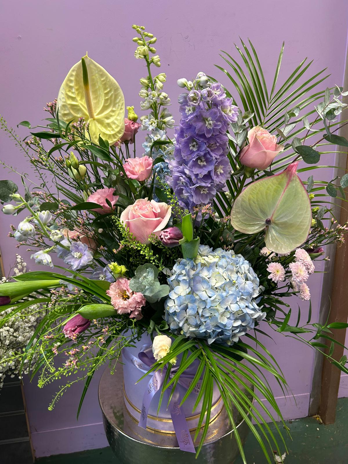 Pastel Lotty's Signature Hatbox with blue hydrangea, pink roses, delphinium and anthurium