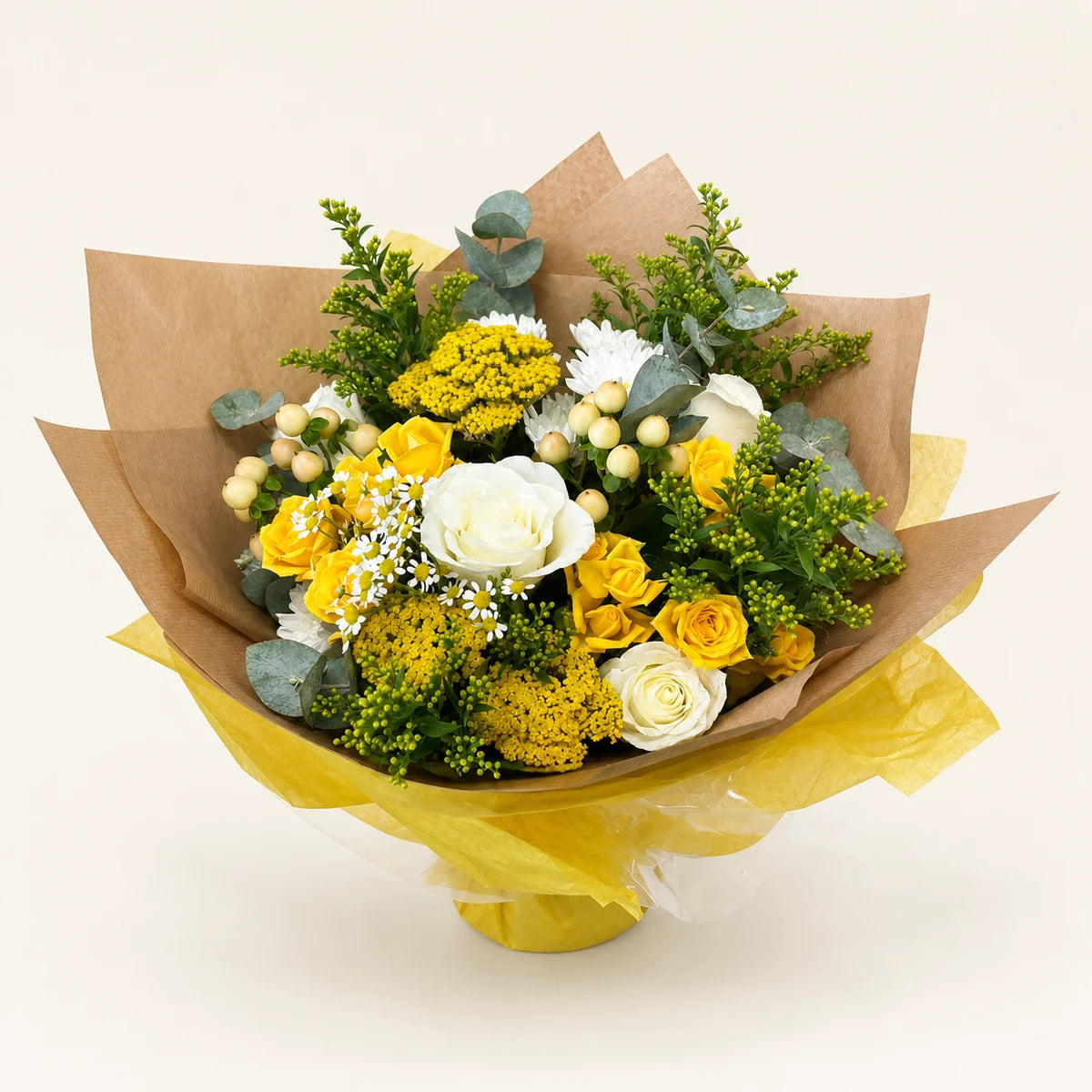 The Pistachio bouquet with yellow and white roses, chrysanthemums and eucalyptus in kraft paper wrapping