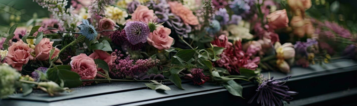 Pink and purple casket flowers with roses and green foliage