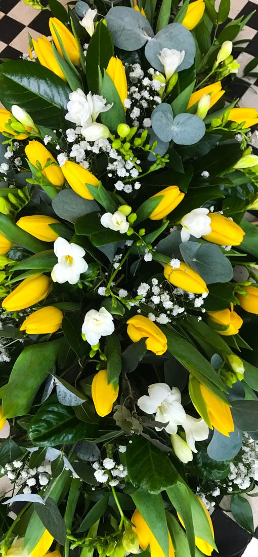 funeral yellow tulips casket top
