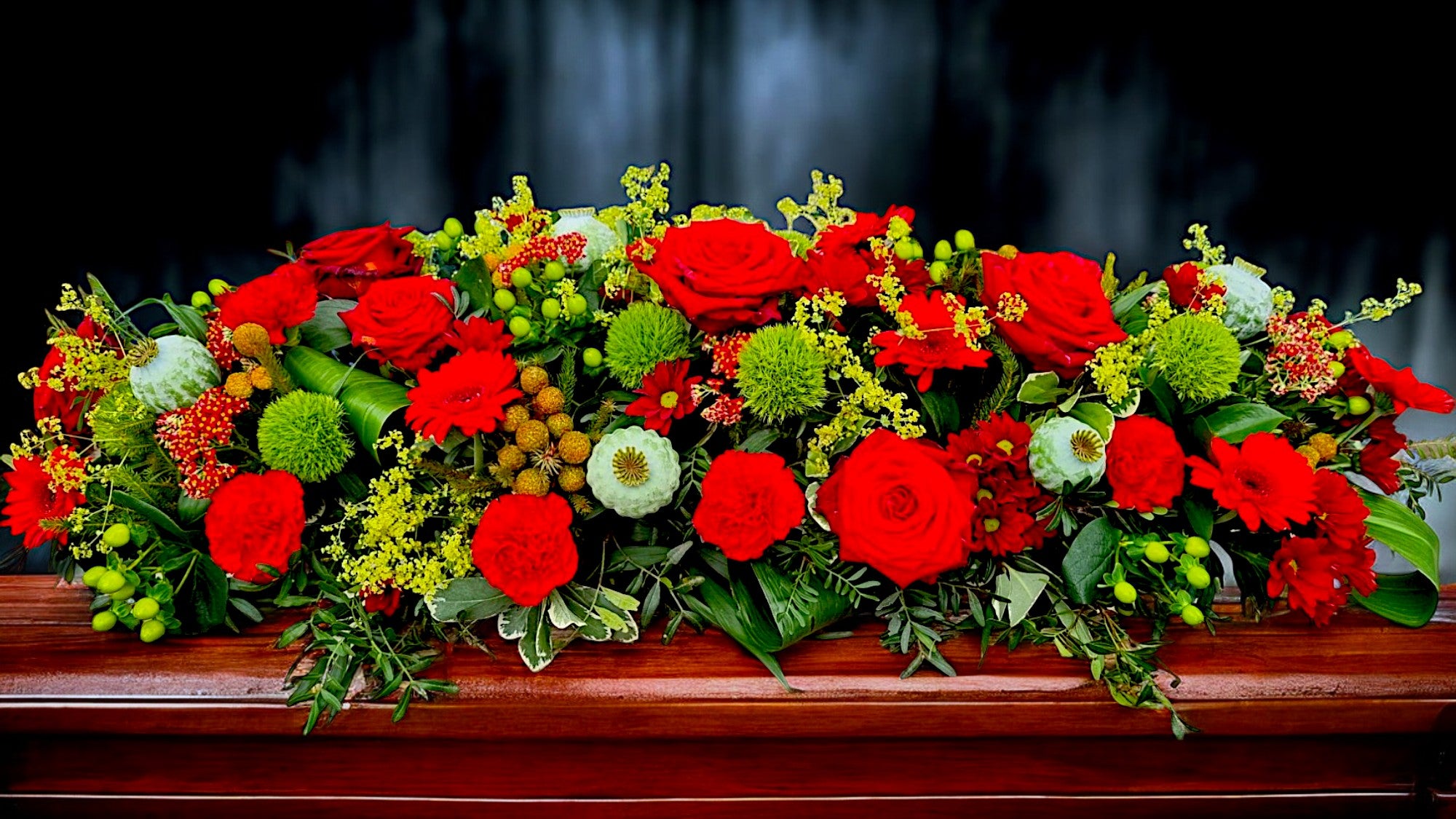 Red Roses and greens funeral piece