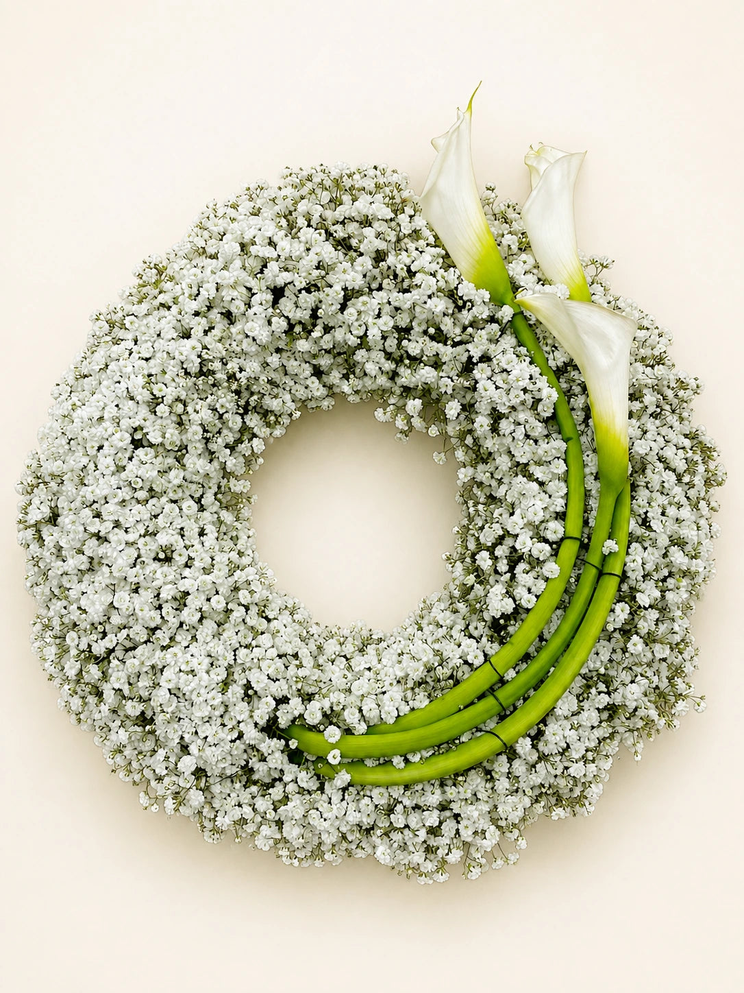 White gypsophila funeral wreath with calla lilies and long curved green stems