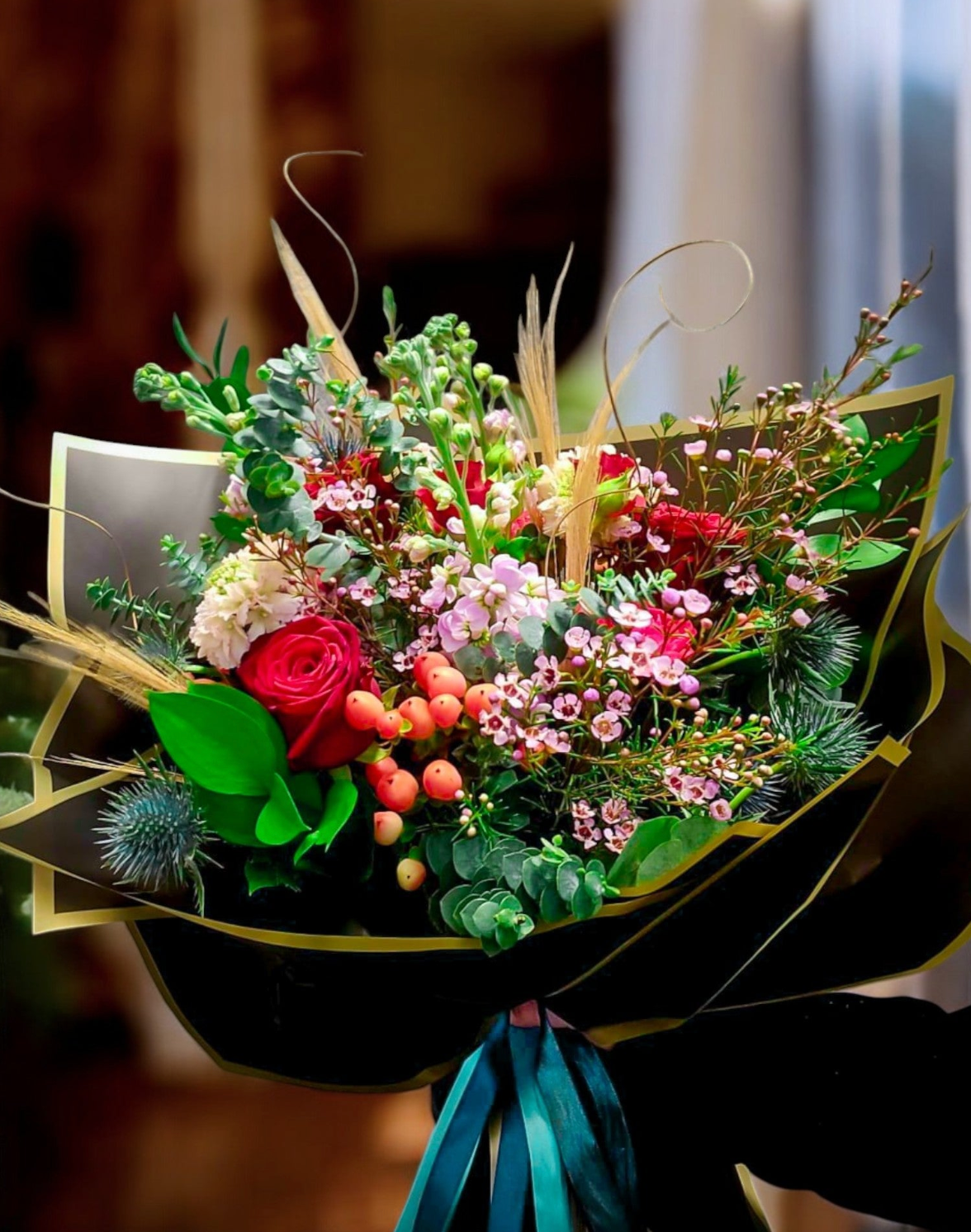 Person holding Lotty's Signature Romance Bouquet