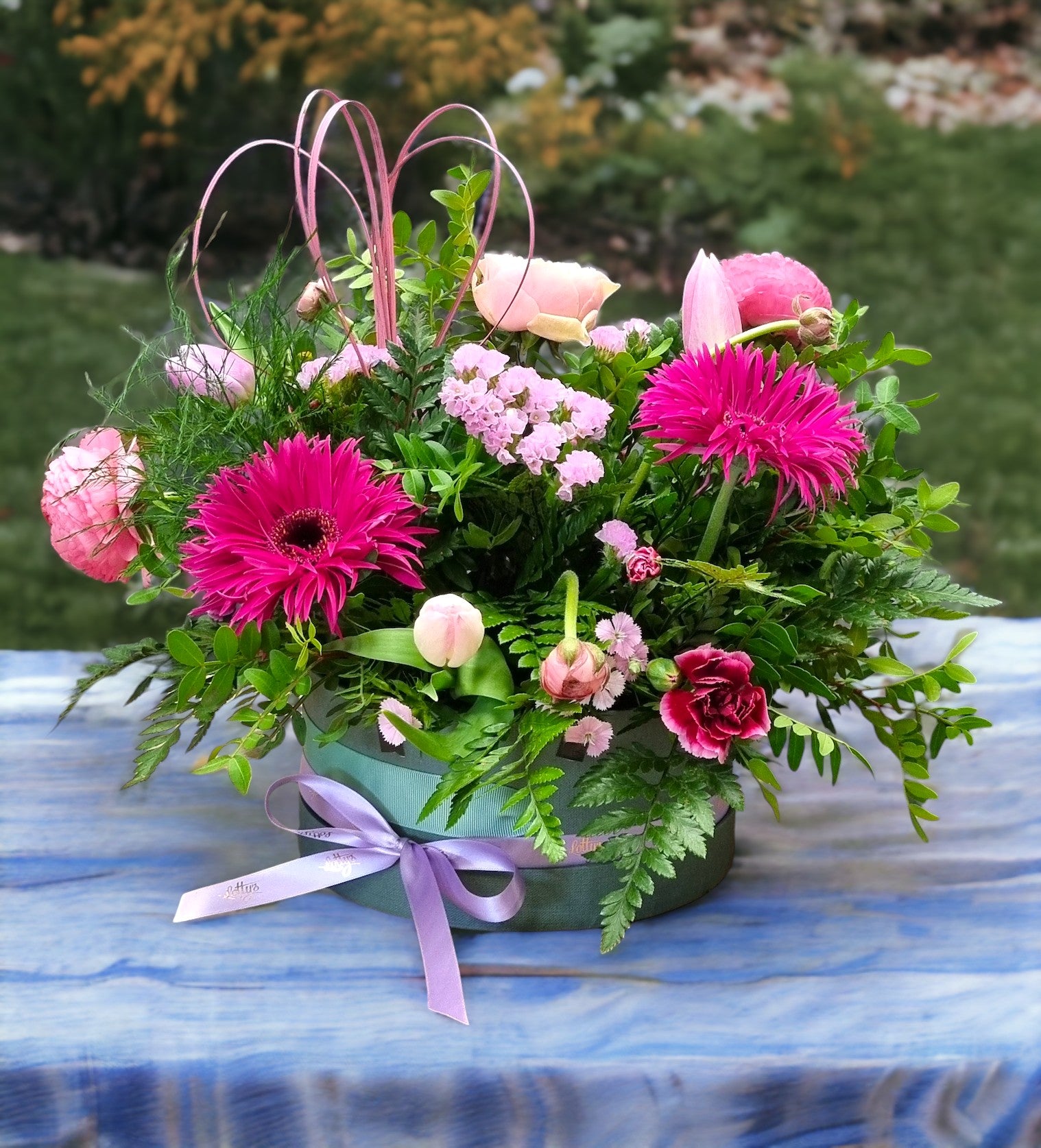 Lavender hatbox with lilac hydrangea, purple stocks, pink roses and eucalyptus