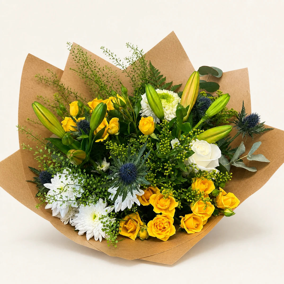 The Pistachio bouquet with yellow roses, white chrysanthemums, lilies, blue thistles and greenery