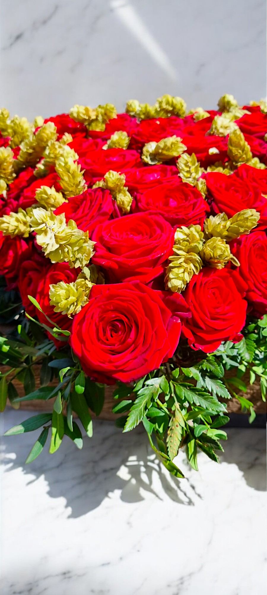 Detail in red rose sympathy tribute