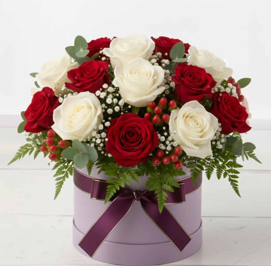 Floral arrangement with red and white roses in a purple box on a white background