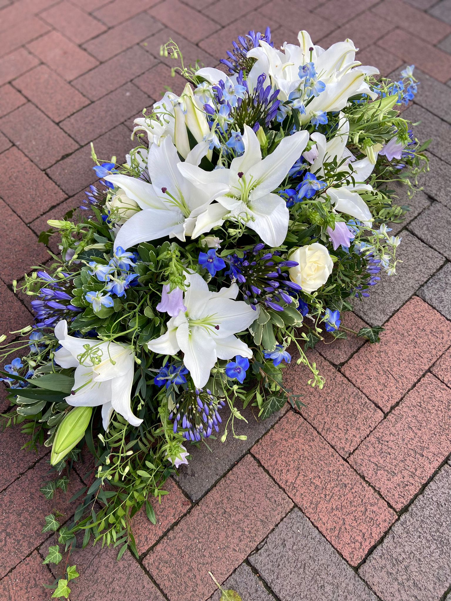 white lilies and blue flowers