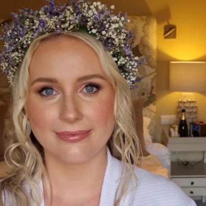 Bride wearing a delicate crown of dried purple and white flowers.