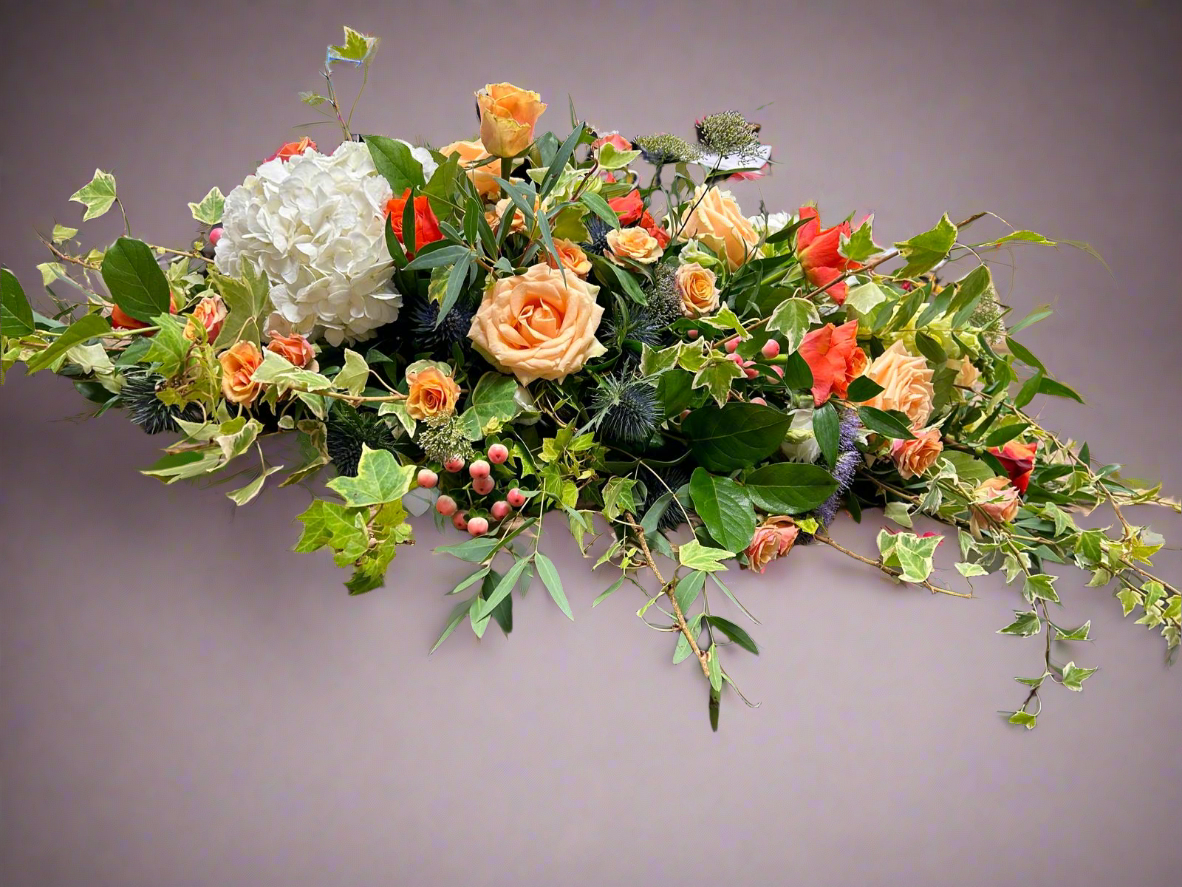 funeral flowers with trailing ivy