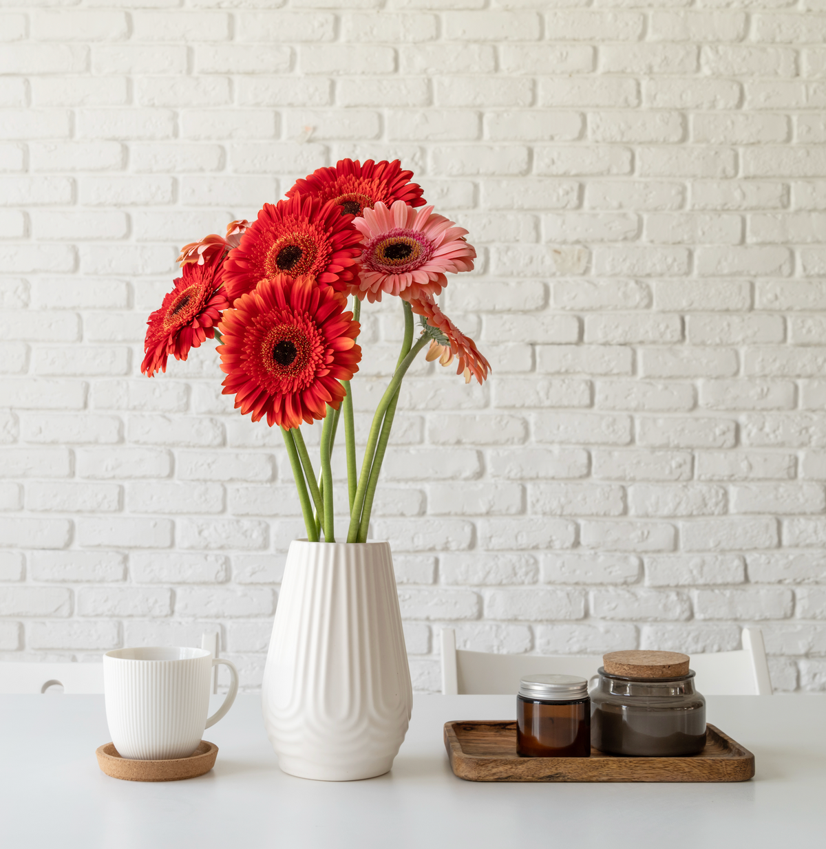 Red gerbera flowers arranged in a vase for a bright floral display.