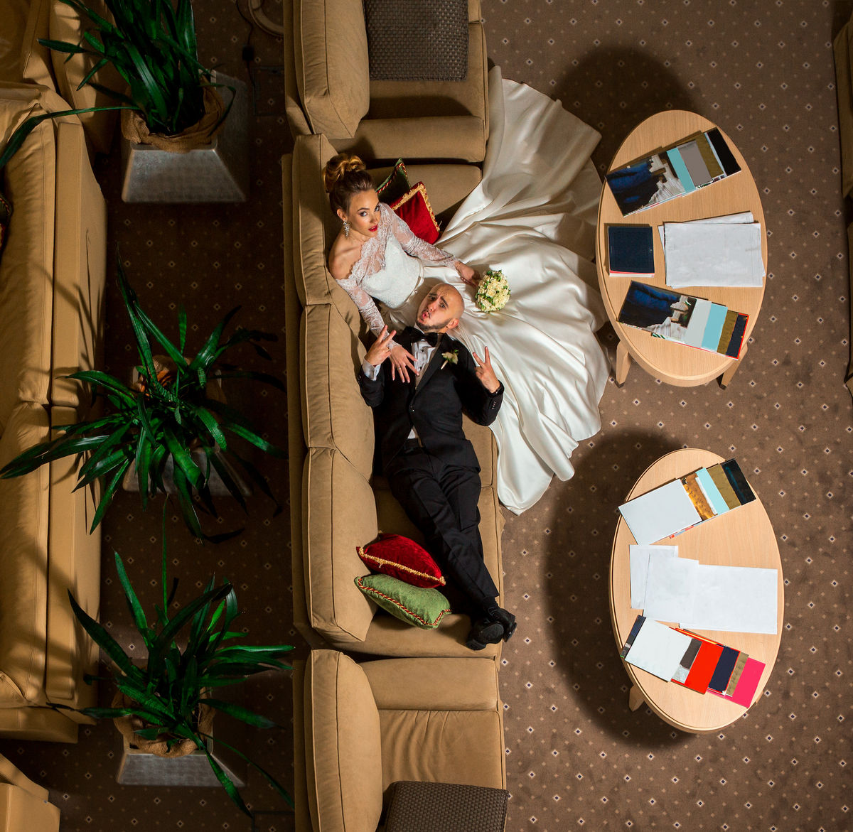Wedding couple sitting together on a sofa in a relaxed wedding portrait.