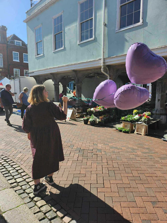 Three lavender heart-shaped helium balloons held outside Lotty’s Flowers shop in Faversham