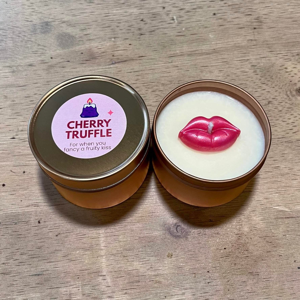 Waxy Beast Cherry Truffle candle in a gold tin with a pink lips decoration and matching labelled lid