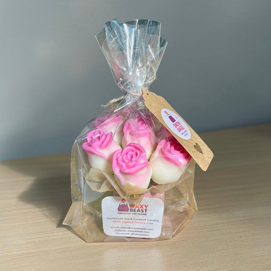 Pink and white rose-shaped wax melts by Waxy Beast, arranged as a bouquet in clear gift wrapping