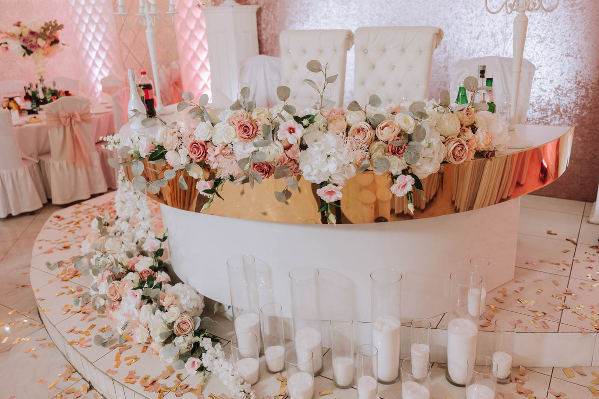Wedding table display with floral arrangements and reception decorations.