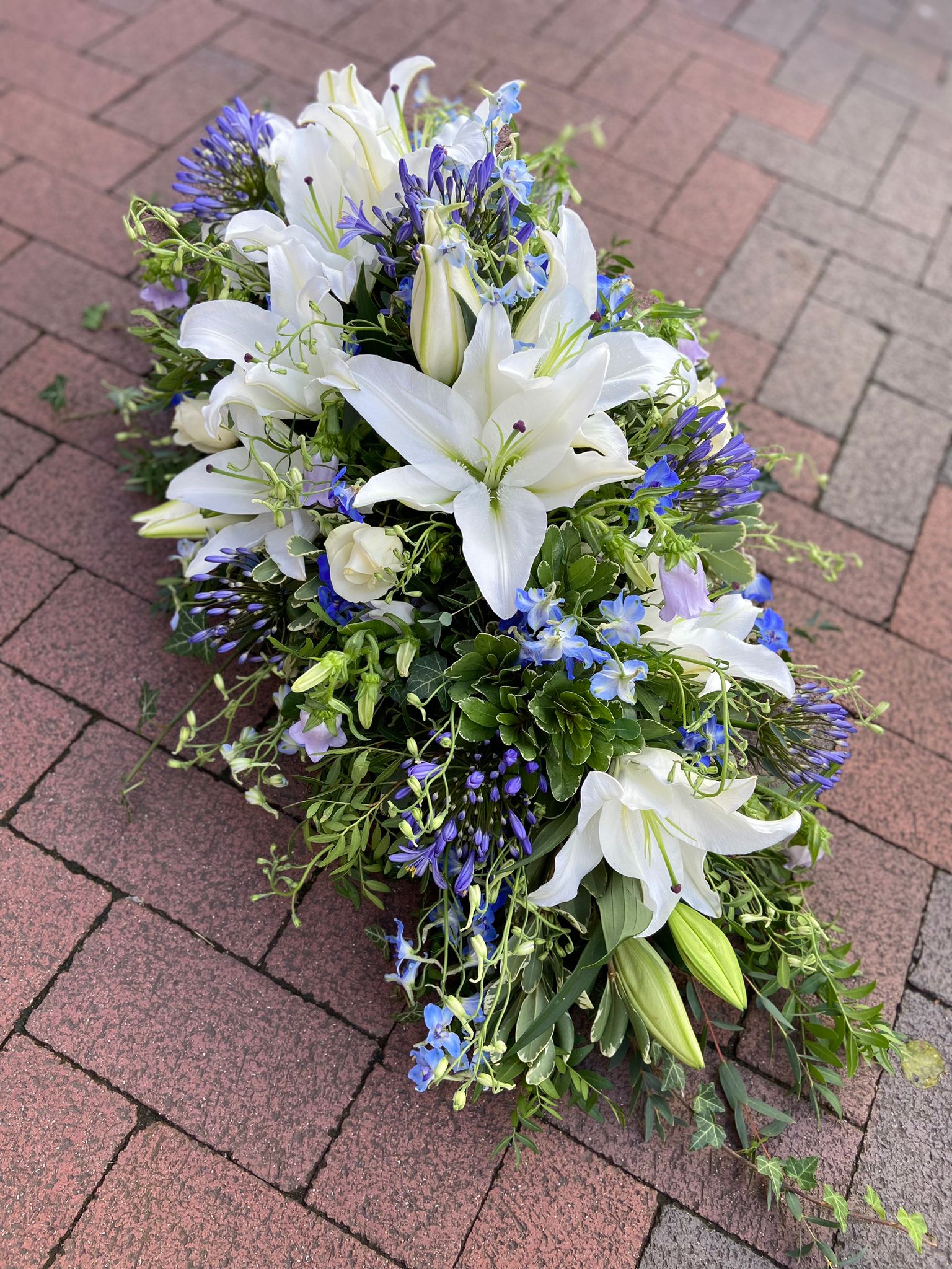 white and blue funeral flowers